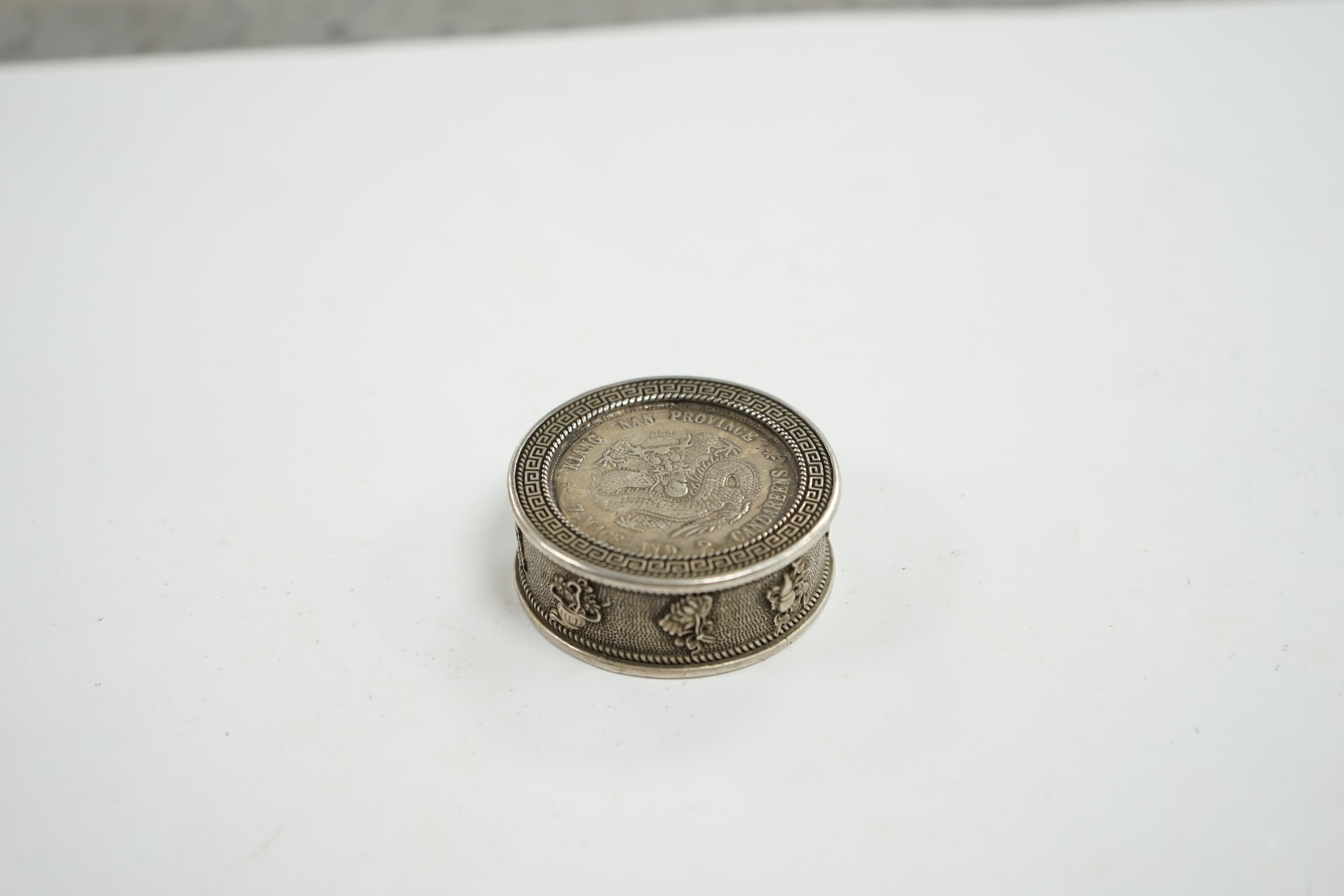 A Chinese white metal coin box and stamps, coin box 5cm diameter. Condition - coin box interior marked, stamps appear fair